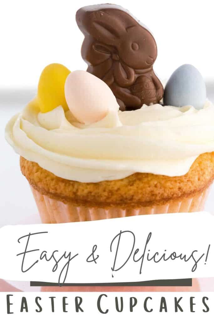 An easter cupcake with candy eggs and chocolate bunnny on top