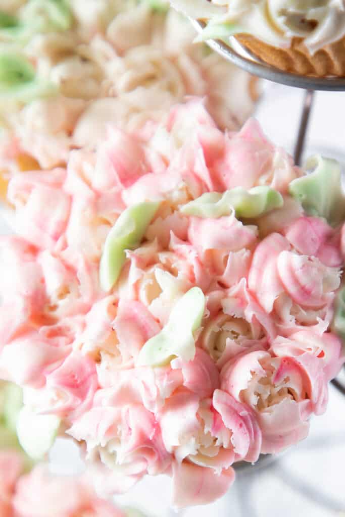 cupcakes with pink frosting flowers on them