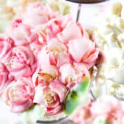 Cupcakes with frosting flowers on them.