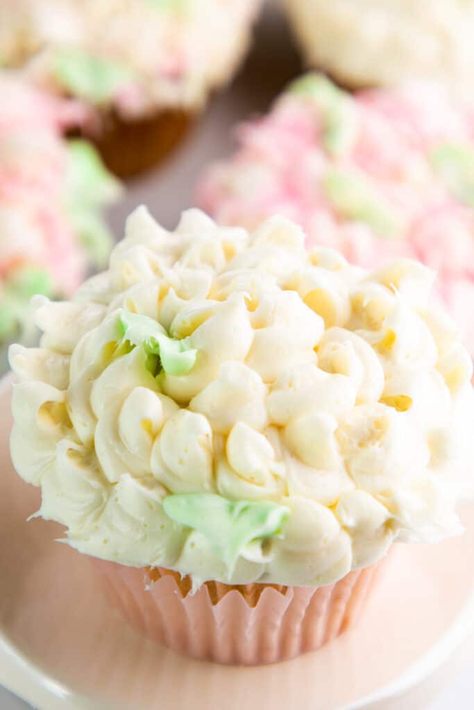 a cupcake with a white flower piped onto it