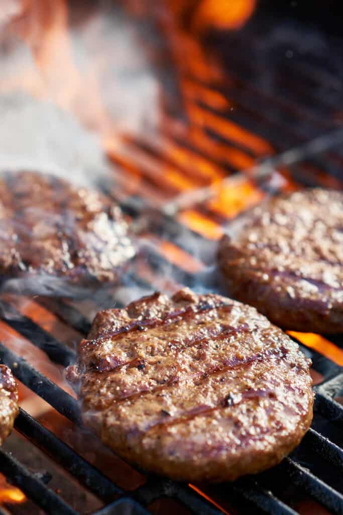 hamburgers cooking on the grill