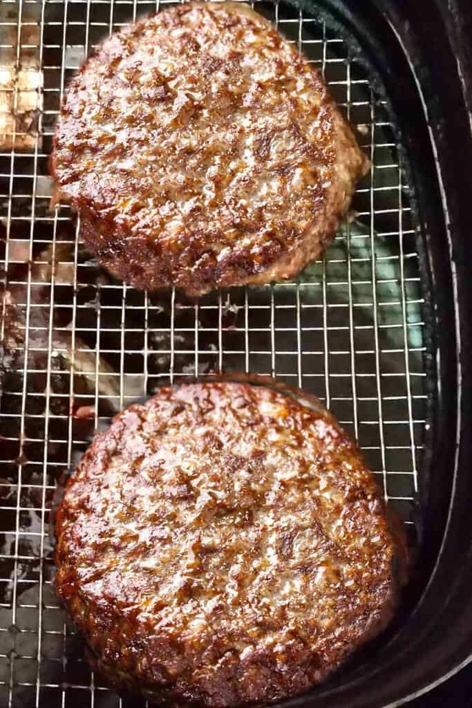 hamburgers cooking in an air fryer