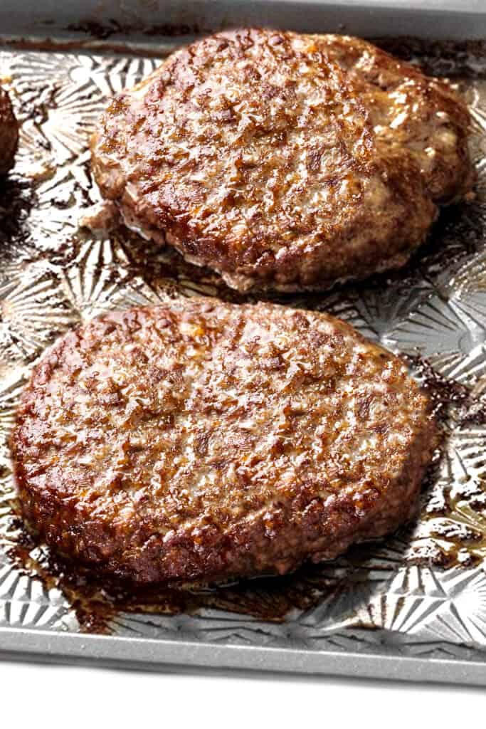 baked burgers on a sheet pan