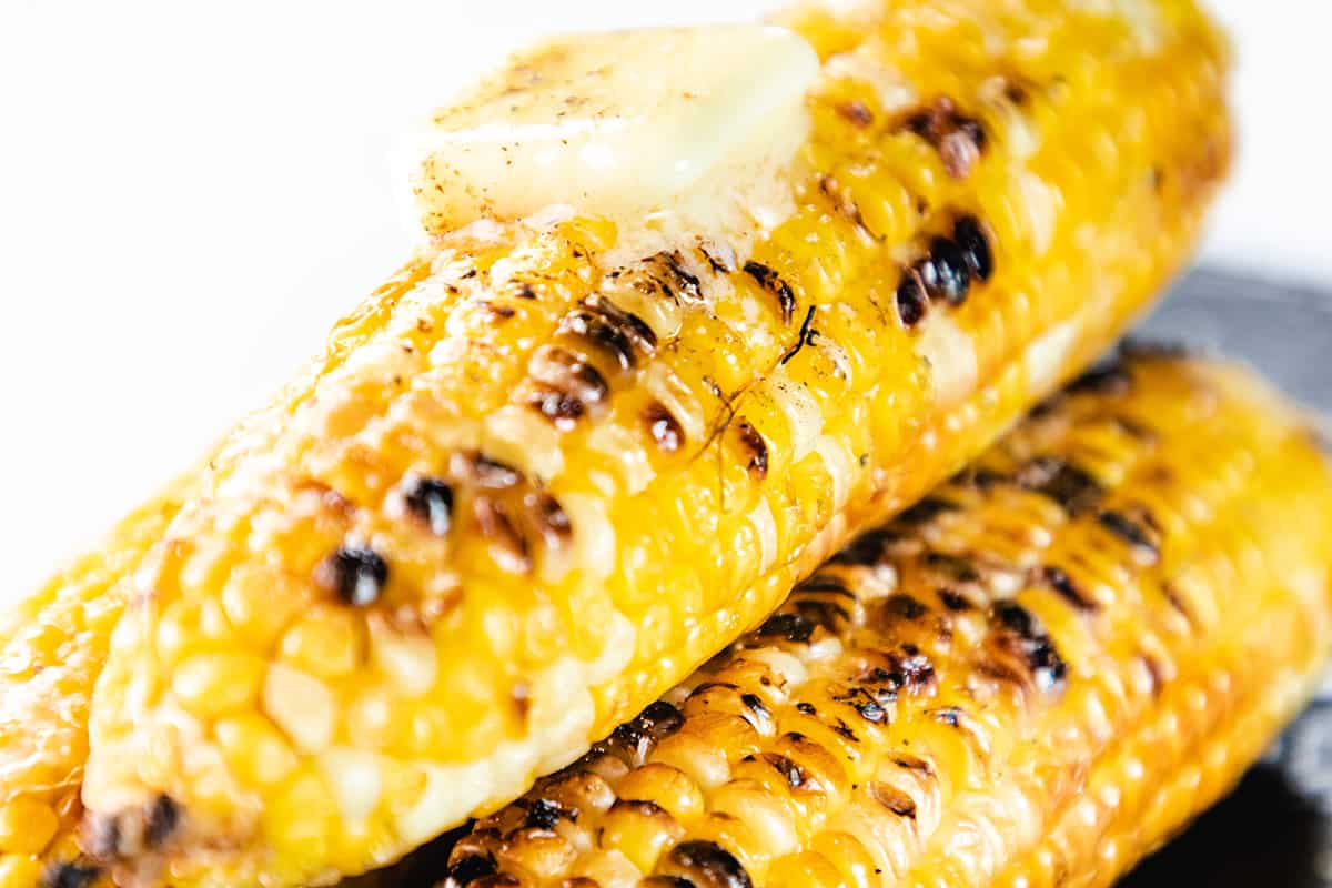 grilled corn on the cob topped with butter, salt and pepper