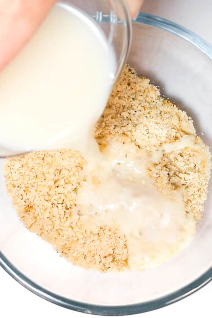 Milk being poured into breadcrumbs