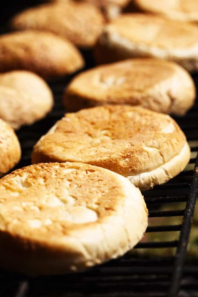 burger buns placed face down on a grill