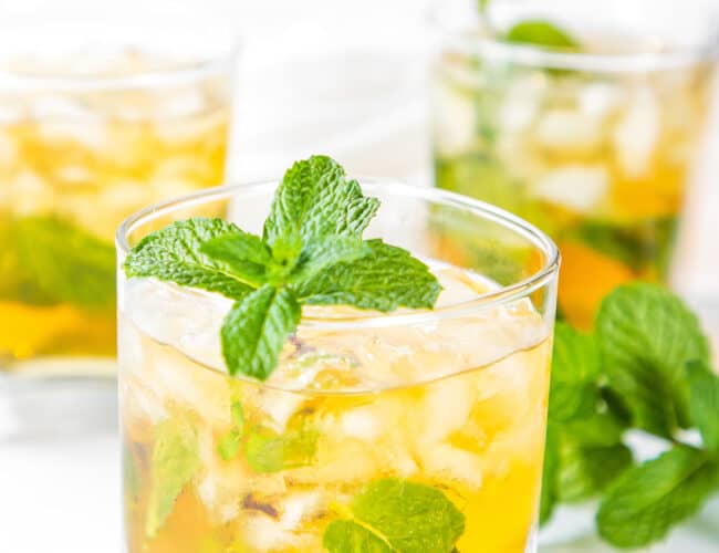 three glasses of Mint Julep Cocktail garnished with a sprig of mint