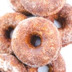 A pile of Cinnamon Sugar Donuts with a white background.