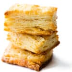 three slices of baked, golden rough puff pastry