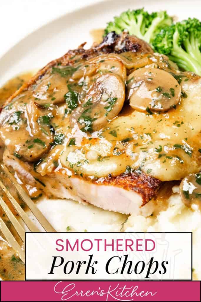 A plate with smothered pork chops coated in a mushroom and herb sauce rests over mashed potatoes, accompanied by broccoli. A fork sits beside the feast, labeled with "Smothered Pork Chops" from "Erren's Kitchen.