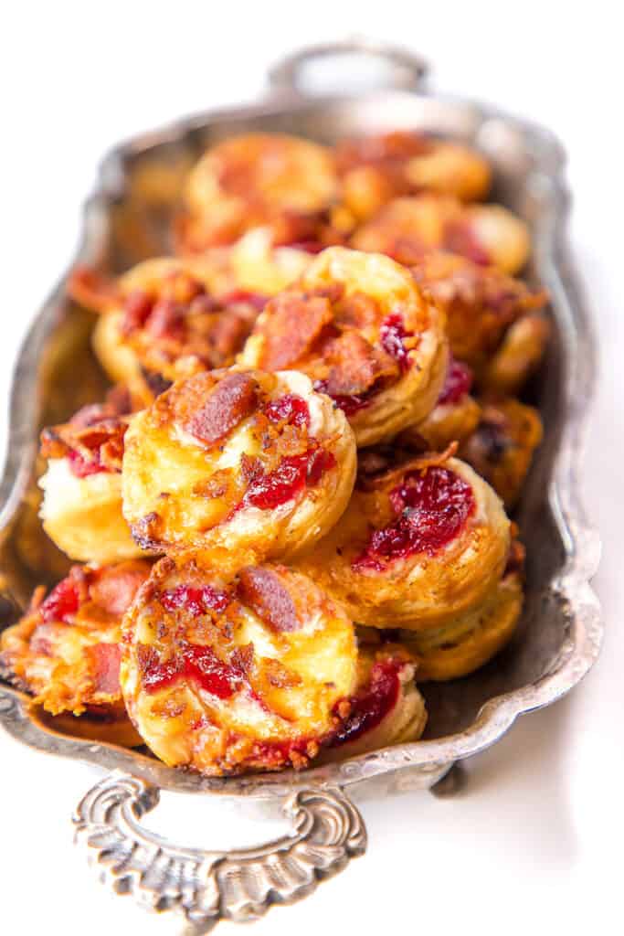 Brie Bites filled with cranberry and bacon on a serving platter