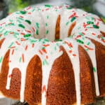 an eggnog bundt cake topped with glaze and holiday sprinkles