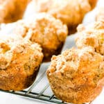 a cooling rack full of Cinnamon Banana Crumb Muffins