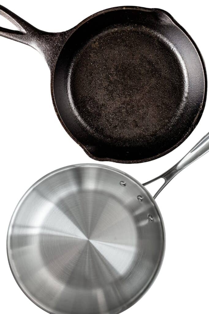 a stainless steal and cast iron pan with white background