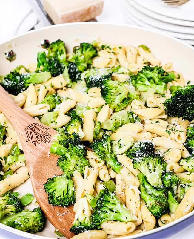 a serving spoon in a big pan of Cavatelli and Broccoli