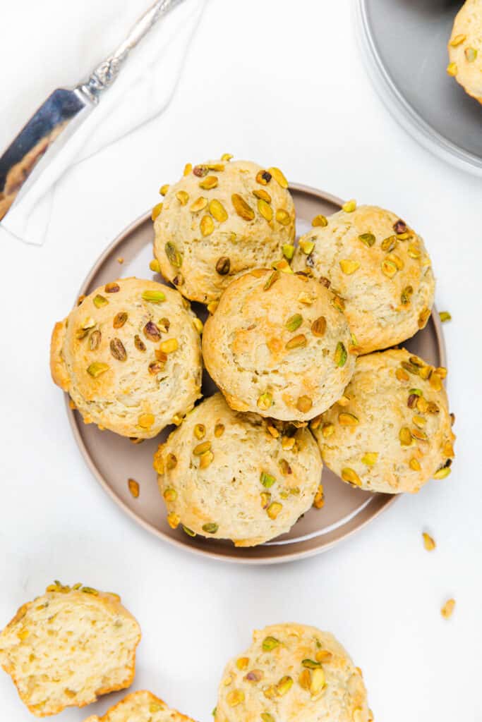 an overhead image of a plate of freshly baked Pistachio Muffins