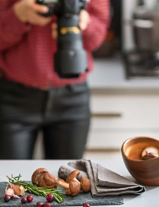 a food photographer looking a camera