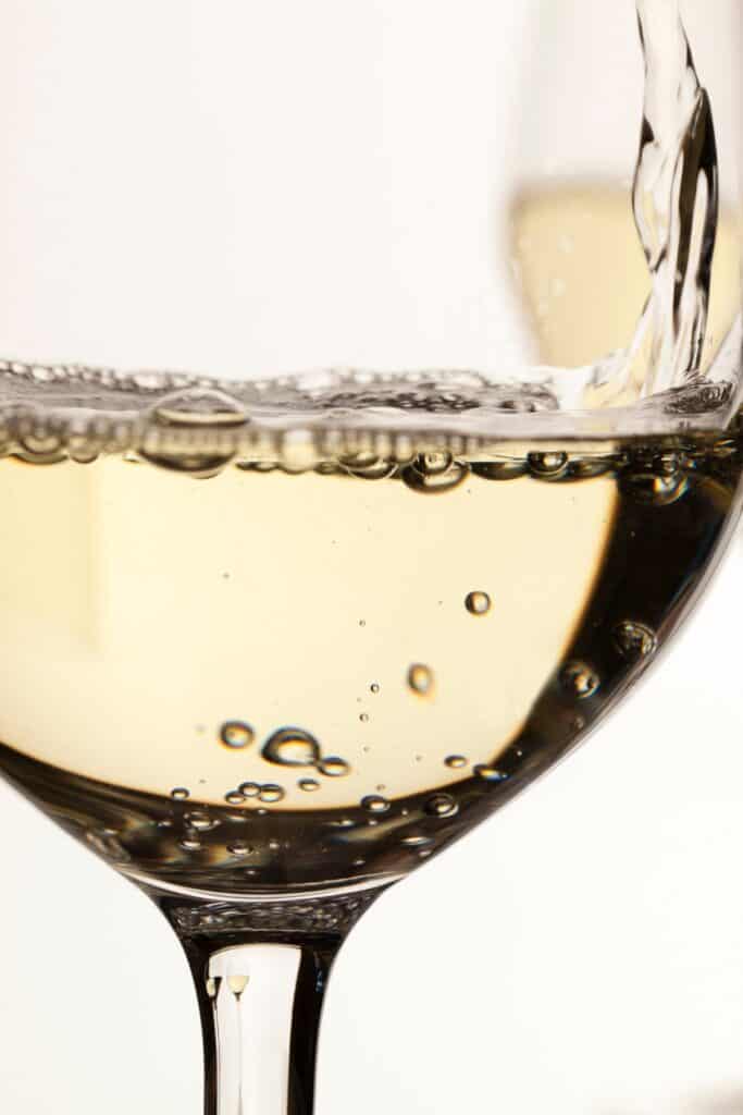 A close up image of yellow plumb wine