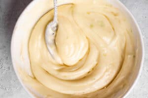 The lime cream cheese frosting in a mixing bowl.