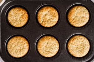 The freshly baked cupcakes in a pan.