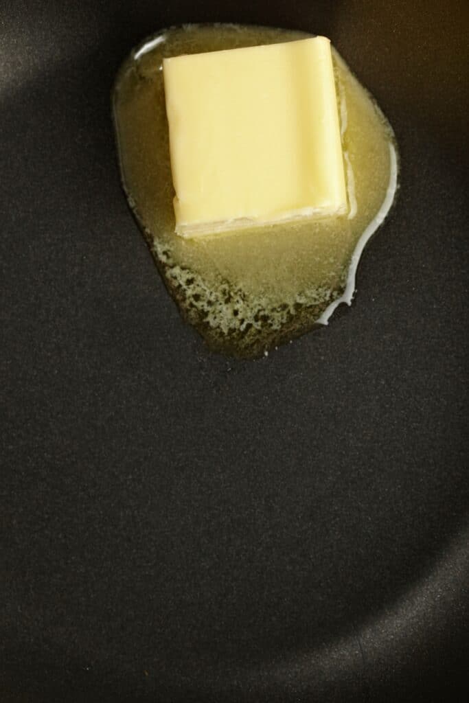 a tablespoon of butter melting in the pan