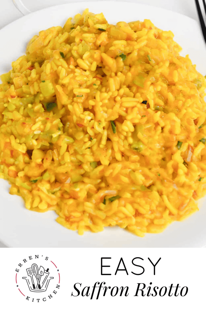 A delicious looking bowl filled with orange colored saffron risotto and sprinkled with parsley on top.