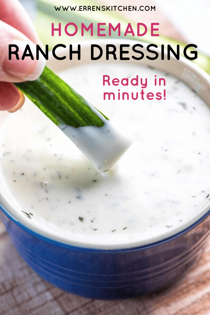 A celery stalk being dipped into a bowl of homemade ranch dressing.