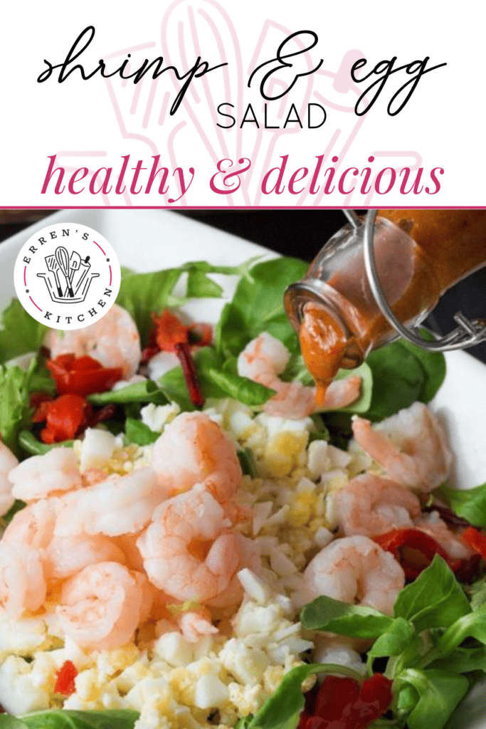 A delicious salad topped with peppers, shrimp, and hard boiled eggs.