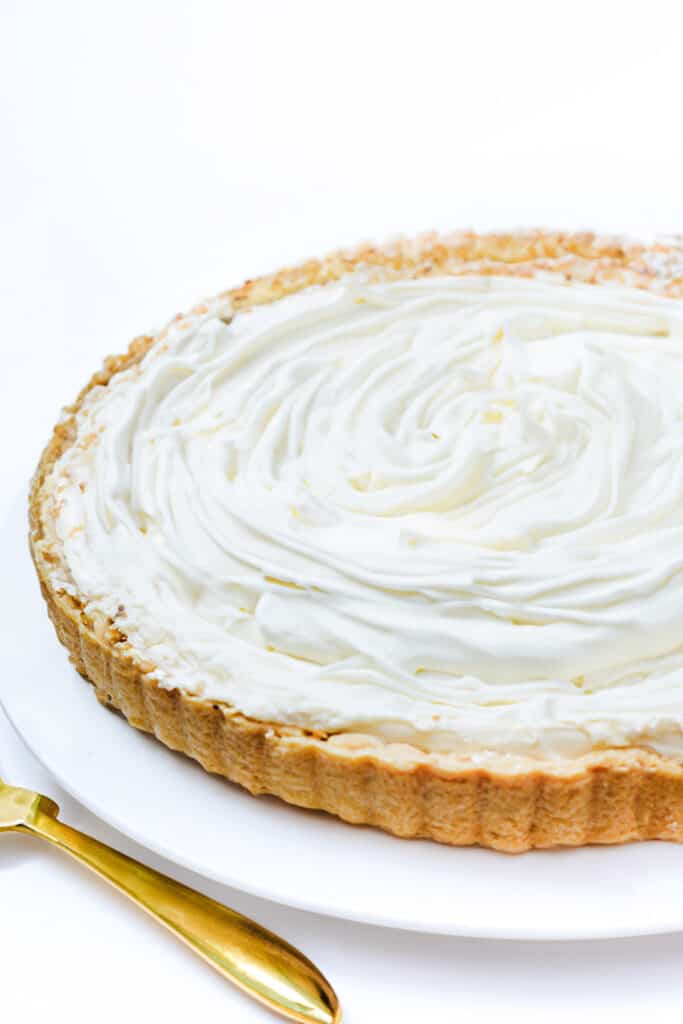 The custard filling of the coconut cream pie covered with whipped cream.