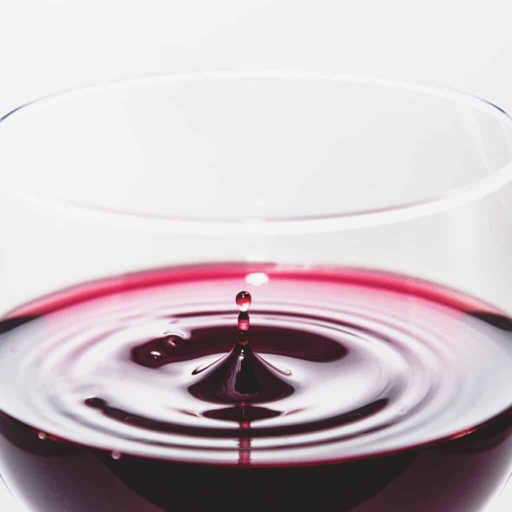 a close up image of a glass of red wine