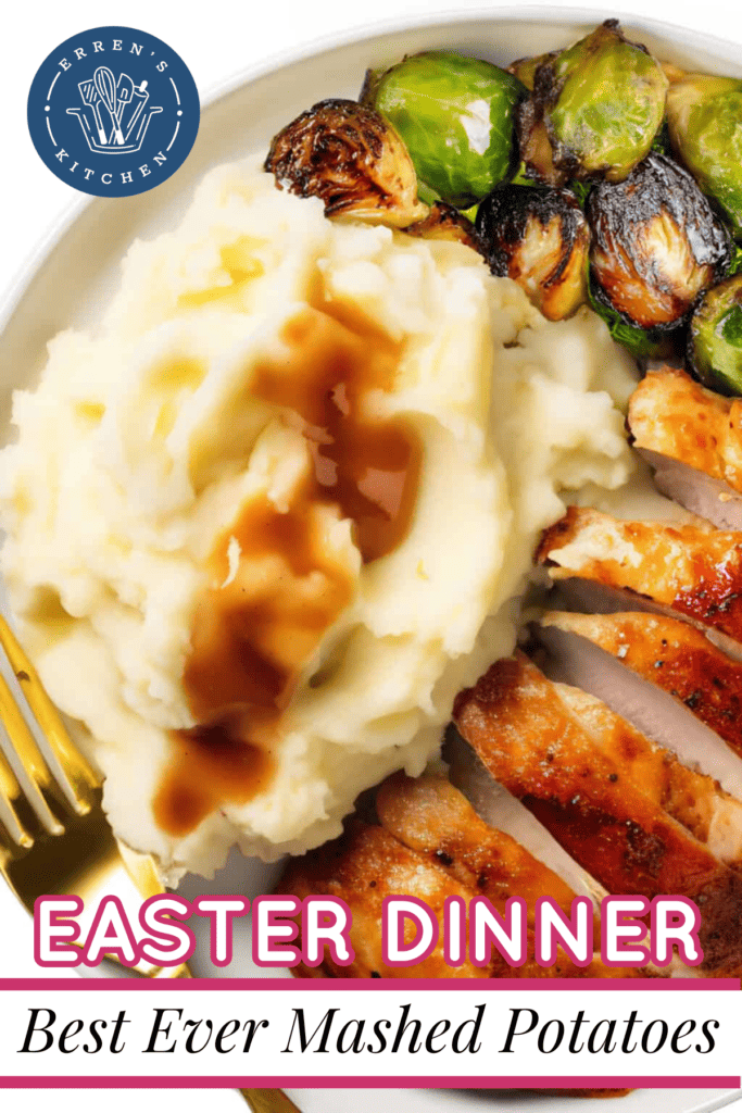 Deliciously creamy mashed potatoes plated with gravy on top, cut chicken breasts, and roasted brussels sprouts.