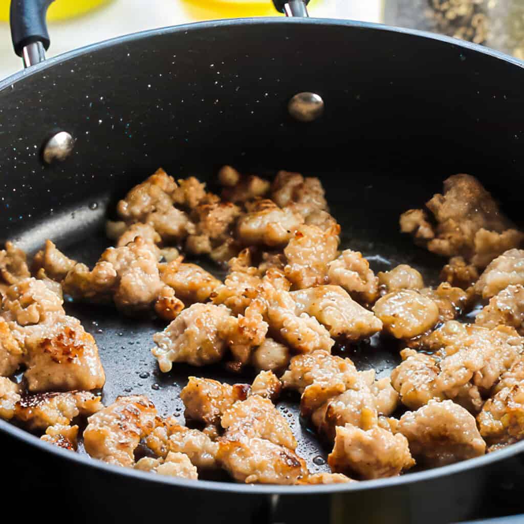 sausage meat cooking on a pan.