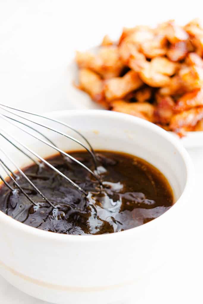 the sauce for the chicken lo mein being mixed in a bowl.