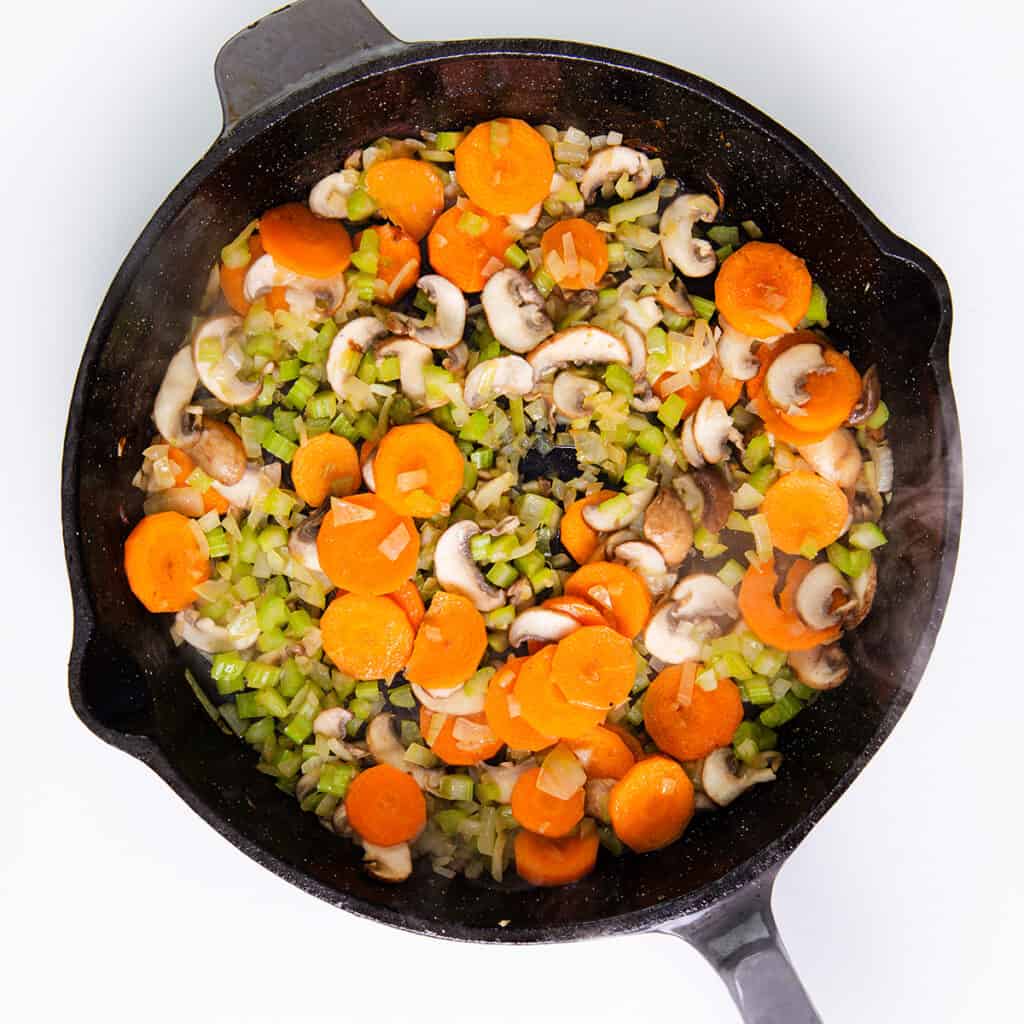 the softened vegetables in the pan.