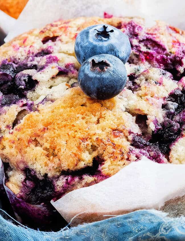 Blueberry muffins with a crumb topping in a serving tray.