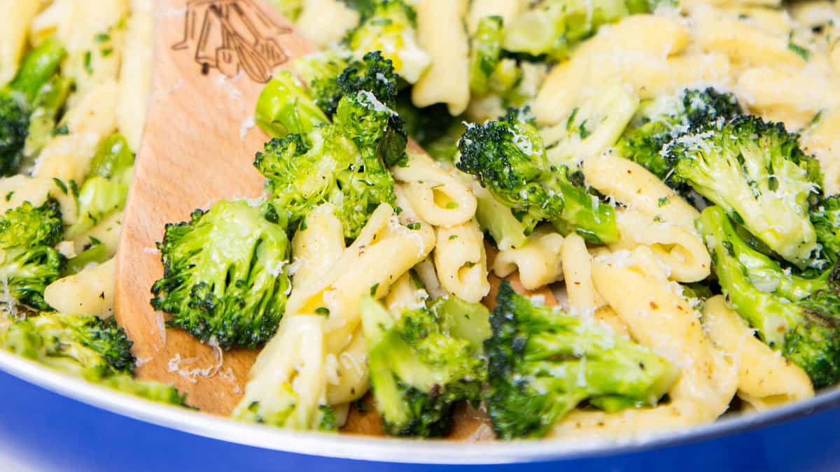 a close up image of a pan of Cavatelli and Broccoli with a serving spoon