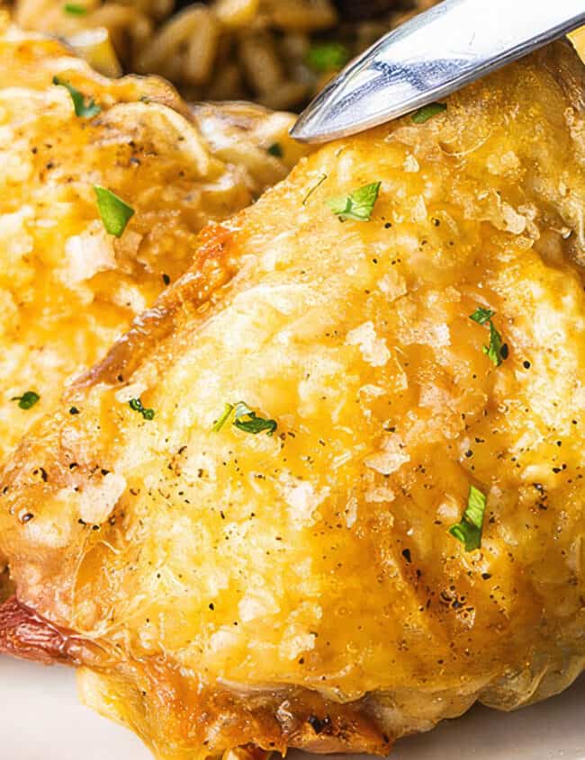 Crispy Oven Baked Chicken Thighs on a plate with some rice.