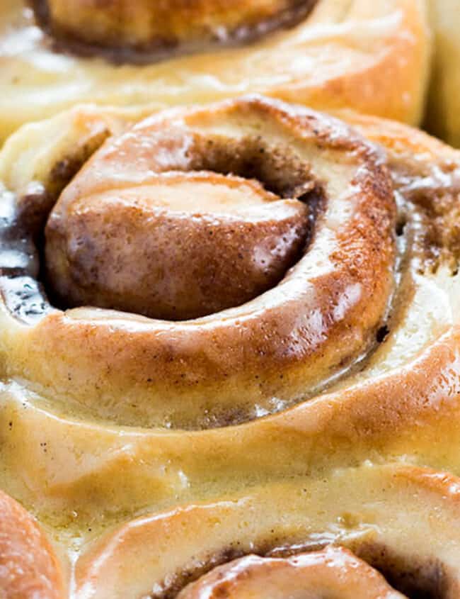 a close up image of freshly baked Cinnamon Rolls in a pan.