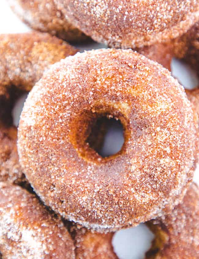 A pile of Cinnamon Sugar Donuts with a white background.