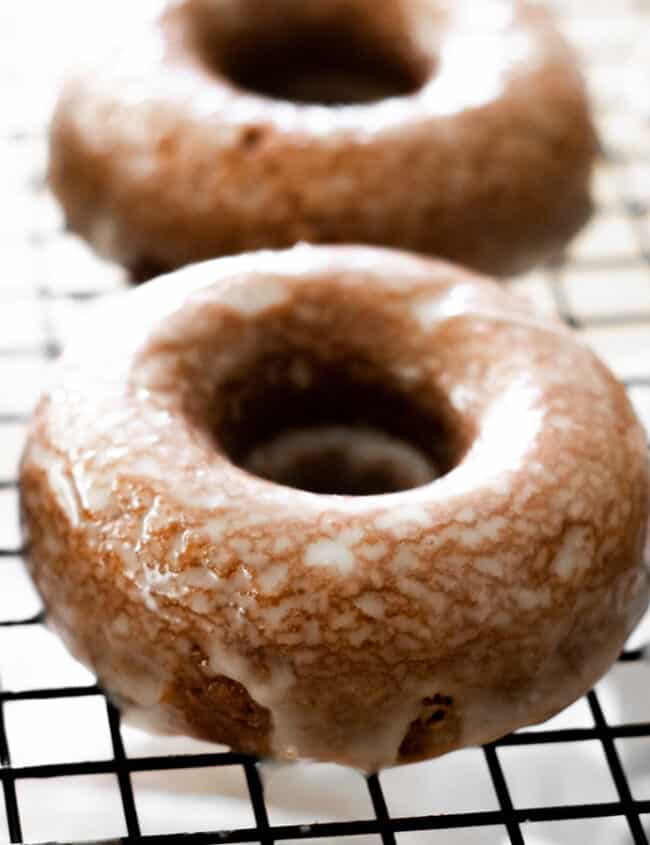 Glazed Chocolate Doughnuts on a cooling rack.