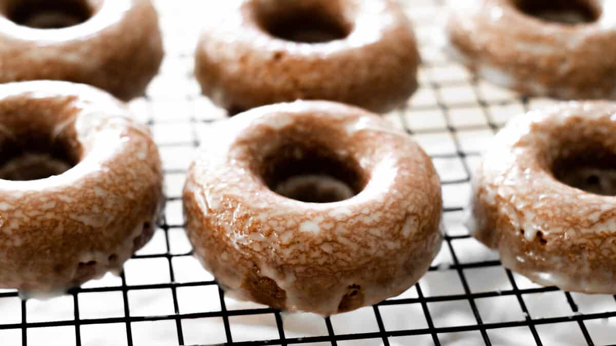 Glazed Chocolate Doughnuts on a cooling rack.