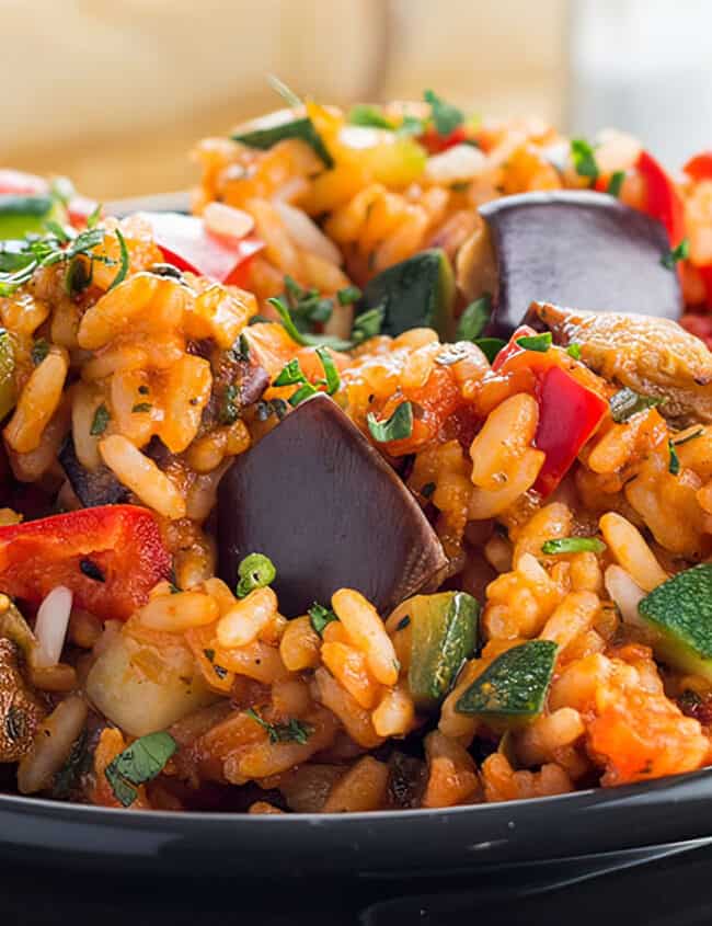 A bowl of Italian Style Rice bursting with roasted vegetables ready to eat.