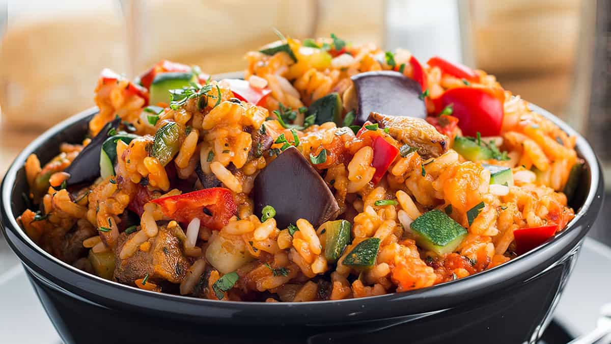 A bowl of Italian Style Rice bursting with roasted vegetables ready to eat.