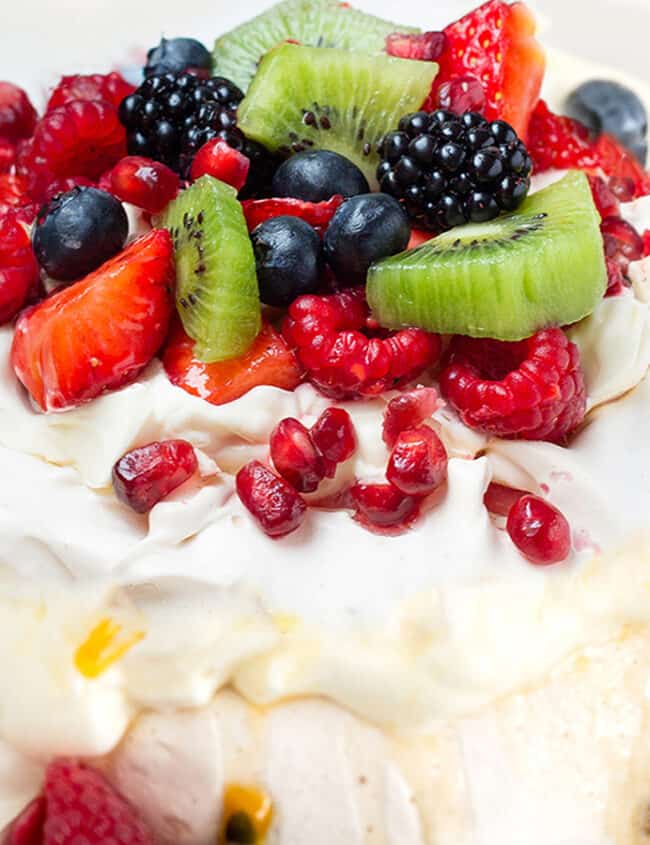 Pavlova with strawberries, blueberries, raspberries and passionfruit.