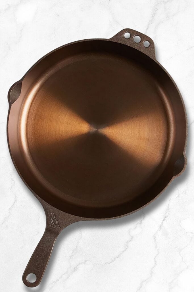 A Smythy Iron Ware skillet on a marble surface.