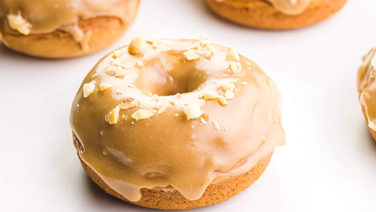 A close up image of a donut glazed with caramel