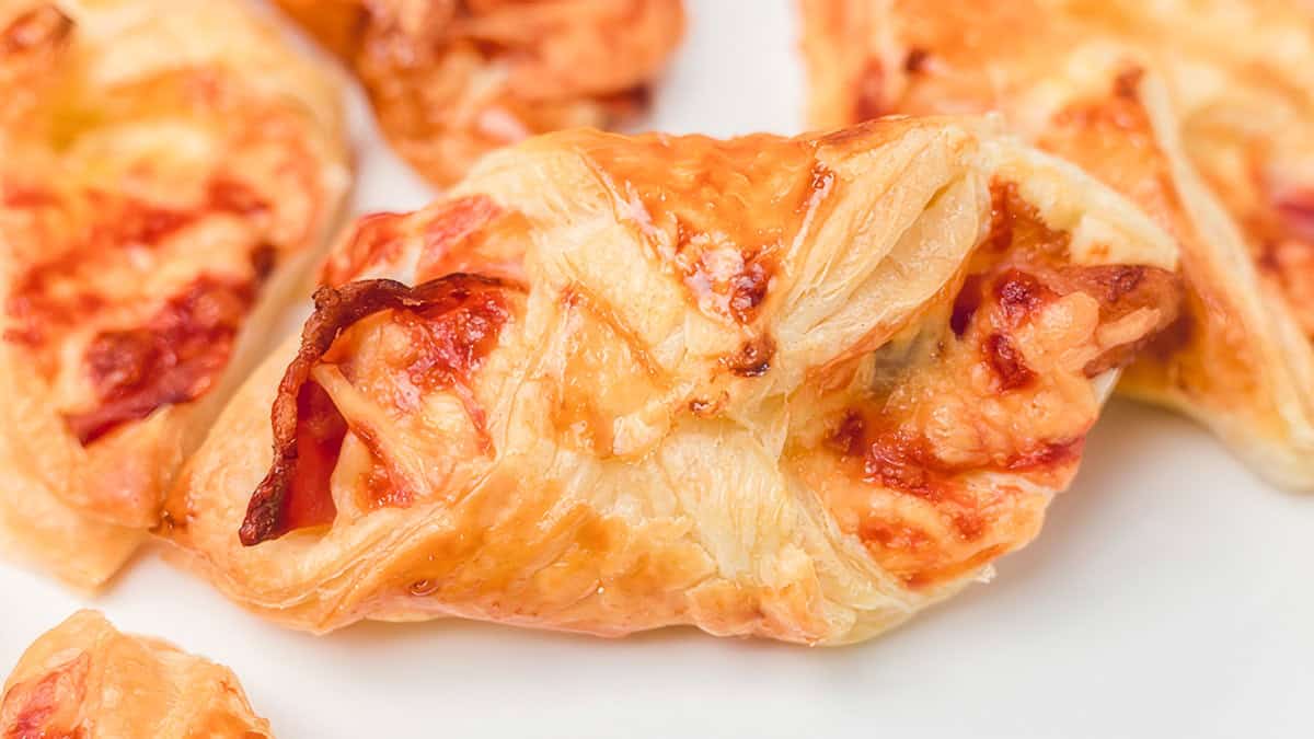 a close up image of crispy cheese and bacon turnovers.