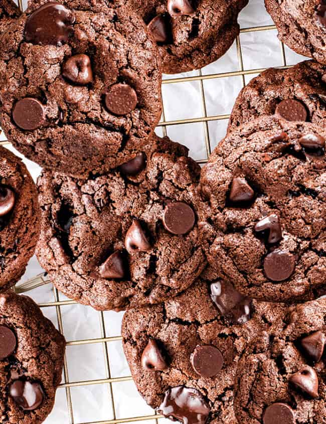 Freshly baked Double Chocolate Chip Cookies on a wire rack.