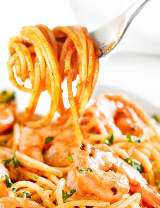 Shrimp spaghetti twirled on a fork.