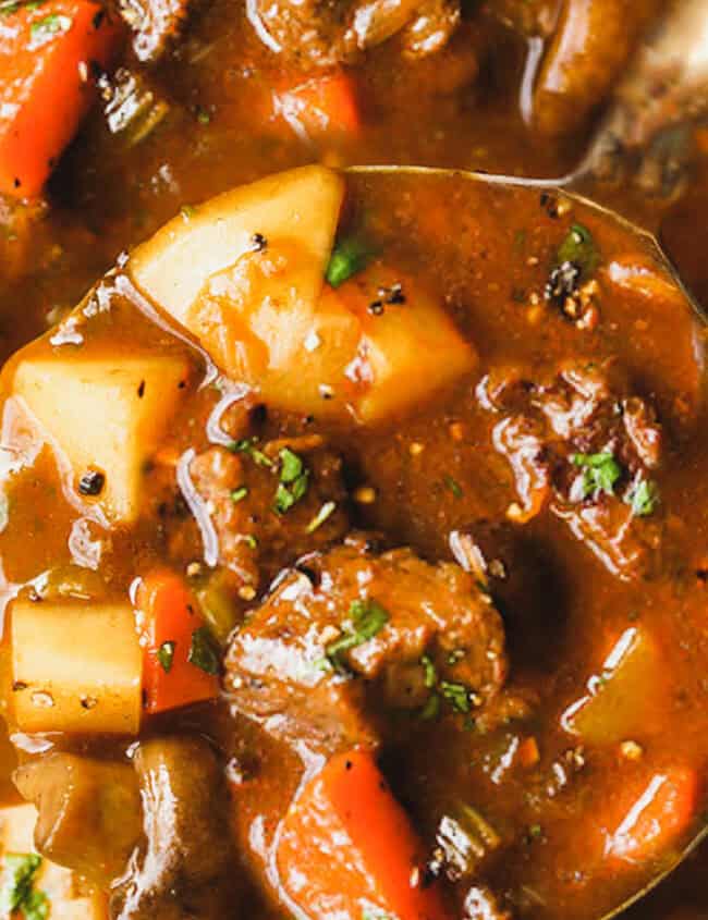 A spoonful of stew over a pot.